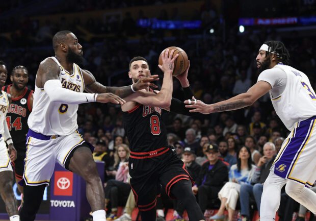 Zach LaVine #8 of the Chicago Bulls drives to the basket in between LeBron James #6 and Anthony Davis #3 of the Los Angeles Lakers during the second half at Crypto.com Arena on March 26, 2023 in Los Angeles, California. NOTE TO USER: User expressly acknowledges and agrees that, by downloading and or using this photograph, User is consenting to the terms and conditions of the Getty Images License Agreement.  Kevork Djansezian/Getty Images/AFP (Photo by KEVORK DJANSEZIAN / GETTY IMAGES NORTH AMERICA / Getty Images via AFP)