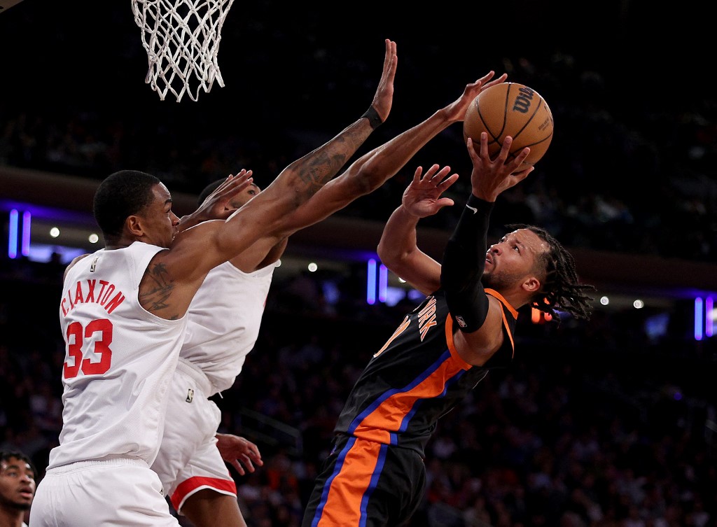 Jalen Brunson #11 of the New York Knicks goes into the net while Nic Claxton #33 and Mikal Bridges #1 of the Brooklyn Nets defend in the second half at Madison Square Garden on March 01, 2023 in New York City.