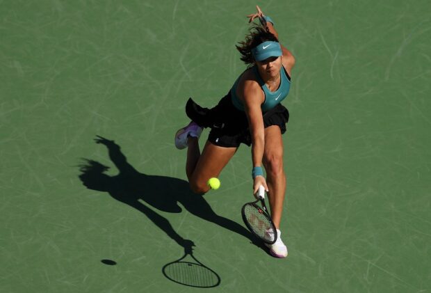 Emma Raducanu of Great Britain in action against Beatriz Haddad Maia of Brazil during the BNP Paribas Open on March 13, 2023 in Indian Wells, California.   J