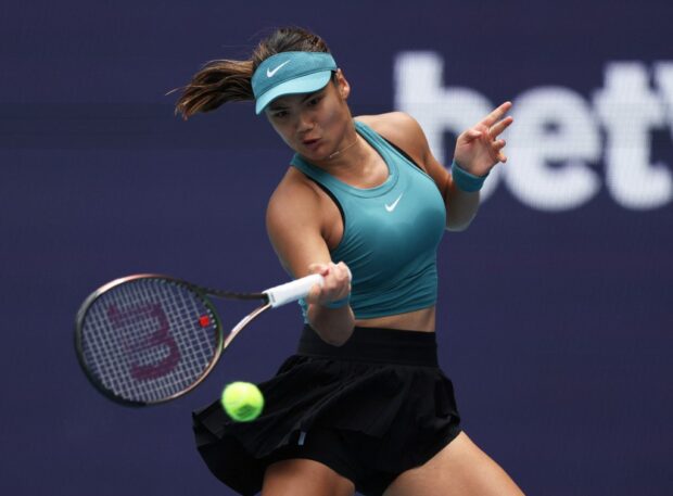  Emma Raducanu of Great Britain plays a forehand against Bianca Andreescu of Canada in their first round match during the Miami Open at Hard Rock Stadium on March 22, 2023 in Miami Gardens, Florida.