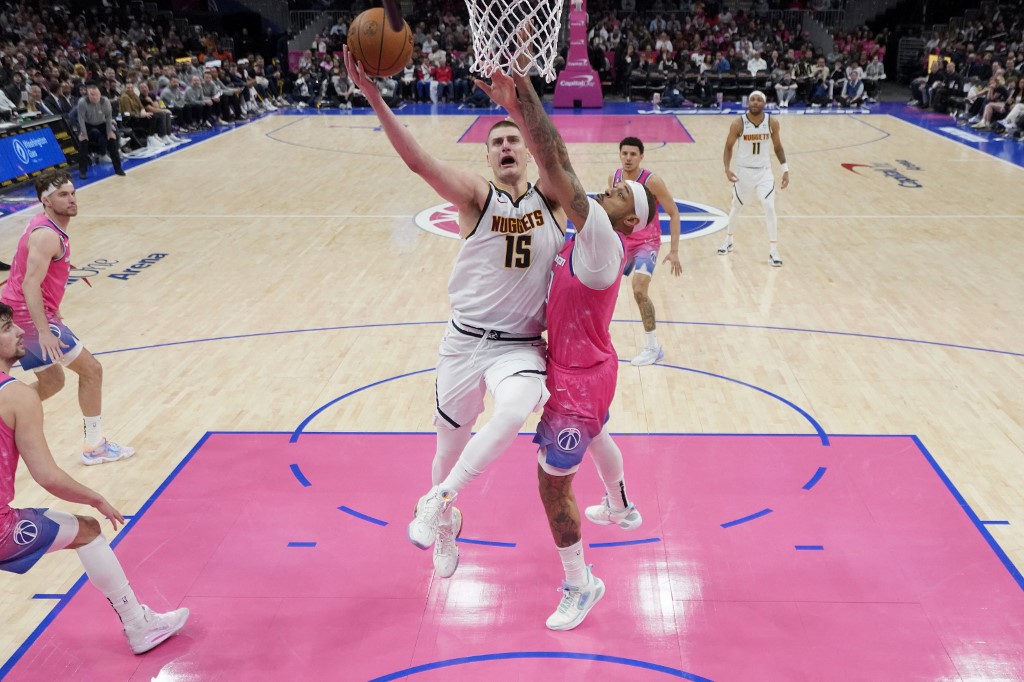 Nikola Jokic #15 of the Denver Nuggets goes up against Daniel Gafford #21 of the Washington Wizards during the second half at Capital One Arena on March 22, 2023 in Washington, DC.