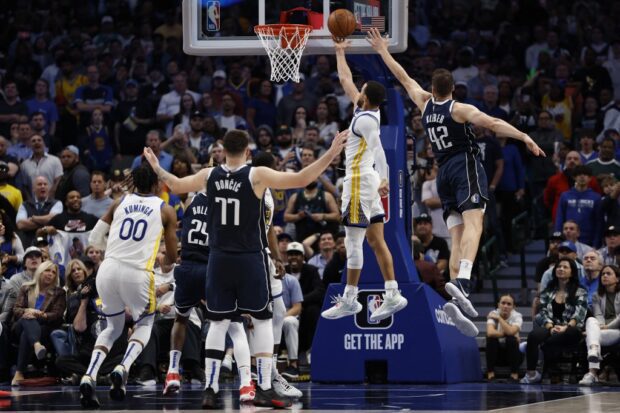 Stephen Curry #30 of the Golden State Warriors scores against Maxi Kleber #42 of the Dallas Mavericks in the second half at American Airlines Center on March 22, 2023 in Dallas, Texas. 