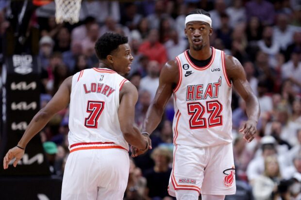 Kyle Lowry #7 and Jimmy Butler #22 of the Miami Heat react on the court during the third quarter of the game against the New York Knicks at Miami-Dade Arena on March 22, 2023 in Miami, Florida.