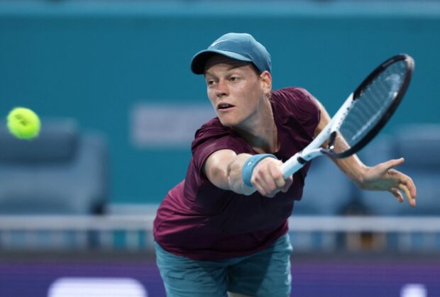 Jannik Sinner of Italy plays a backhand against Emil Ruusuvuori of Finland in their quarterfinal match at Hard Rock Stadium on March 29, 2023 in Miami Gardens, Florida. 