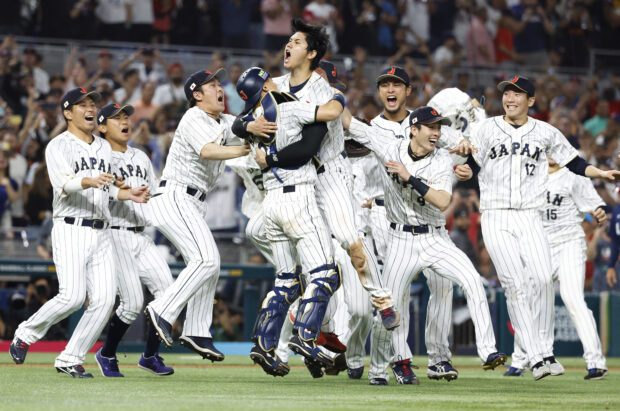 iami, Florida, USA;  Japan designated hitter and closing pitcher Shohei Ohtani (16) and Japan catcher Yuhei Nakamura (27) and team Japan celebrate defeating the USA in the World Baseball Classic at LoanDepot Park.