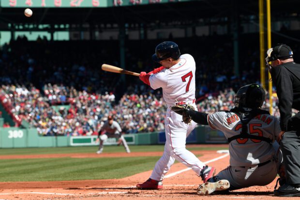 Mar 30, 2023; Boston, Massachusetts, USA; Boston Red Sox left fielder Masataka Yoshida (7) makes a hit against the Baltimore Orioles at Fenway Park.