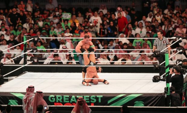 John Cena (C-L) competes with Triple H (C) during the World Wrestling Entertainment (WWE) Greatest Royal Rumble event in the Saudi coastal city of Jeddah on April 27, 2018. (Photo by STRINGER / AFP)