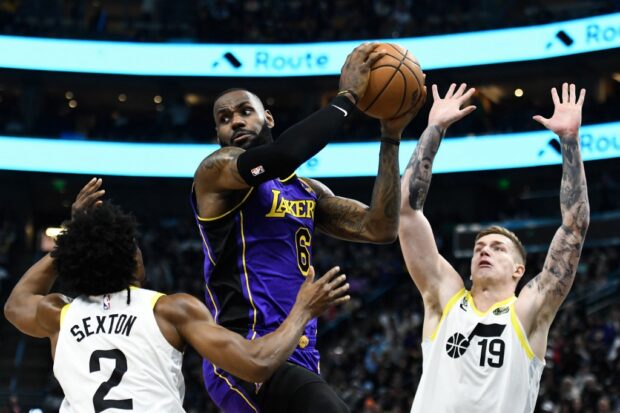  LeBron James #6 of the Los Angeles Lakers looks to pass around Collin Sexton #2 and Luka Samanic #19 of the Utah Jazz during the second half at Vivint Arena on April 04, 2023 in Salt Lake City, Utah