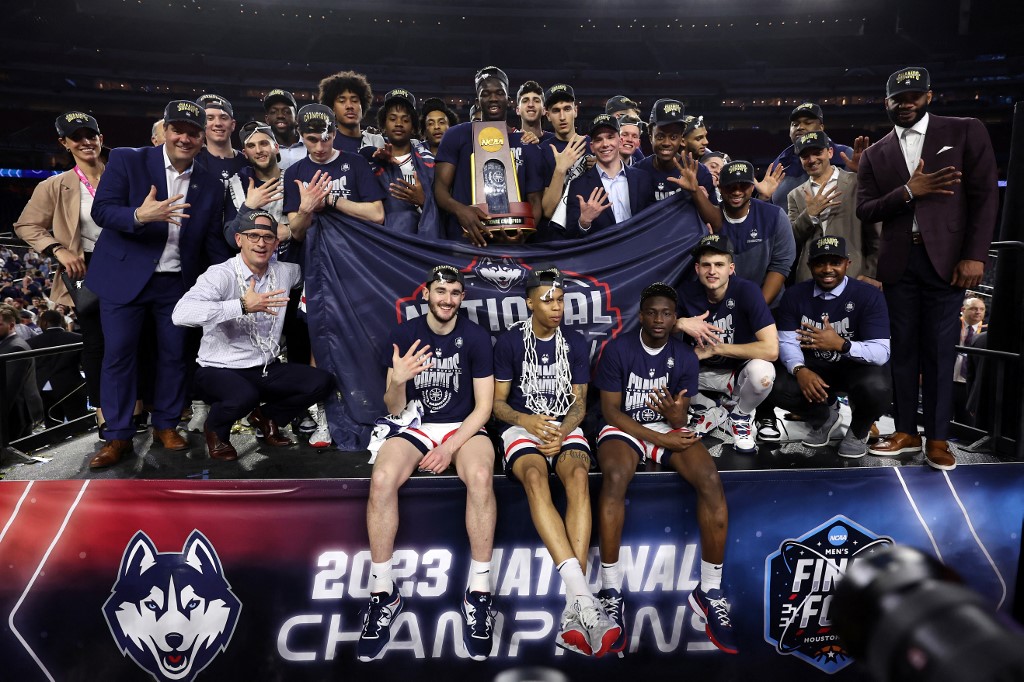 The Connecticut Huskies pose with the championship trophy after defeating the San Diego State Aztecs 76-59 during the NCAA Men's Basketball Tournament National Championship game at NRG Stadium on April 03, 2023 in Houston, Texas.