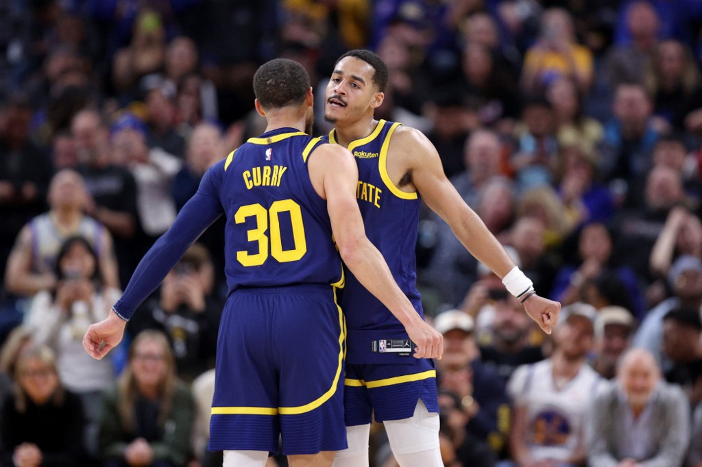 Jordan Poole #3 and Stephen Curry #30 of the Golden State Warriors bump chests during their game against the Oklahoma City Thunder in the second half at Chase Center on April 04, 2023 in San Francisco, California. 