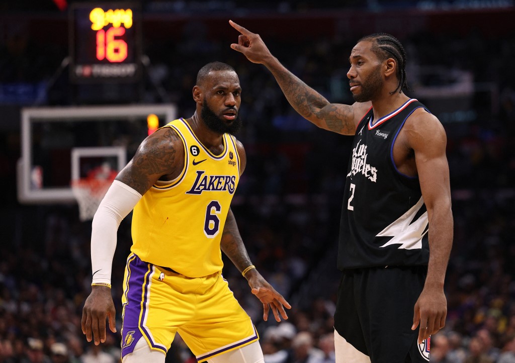 Kawhi Leonard #2 of the LA Clippers directs a play in front of LeBron James #6 of the Los Angeles Lakers during a 125-118 Clippers win at Crypto.com Arena on April 05, 2023 in Los Angeles, California. 
