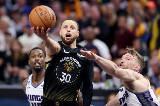Stephen Curry #30 of the Golden State Warriors goes up for a shot on Domantas Sabonis #10 of the Sacramento Kings in the second half of Game Three of the Western Conference First Round Playoffs at Chase Center on April 20, 2023 in San Francisco, California. 