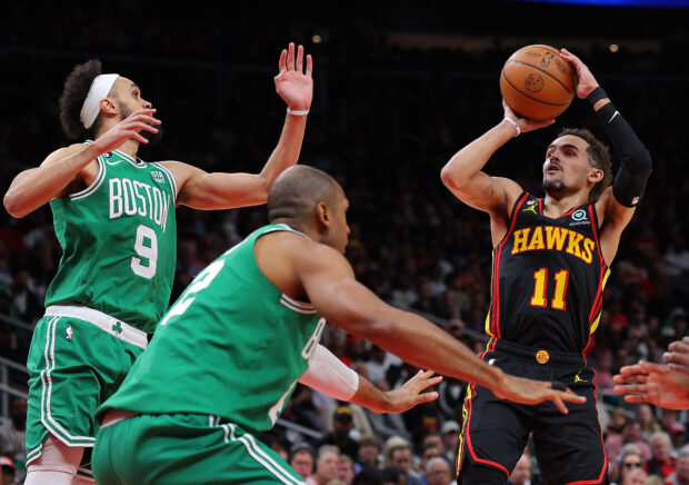 Trae Young #11 of the Atlanta Hawks attempts a shot against Derrick White #9 and Al Horford #42 of the Boston Celtics during the fourth quarter of Game Three of the Eastern Conference First Round Playoffs at State Farm Arena on April 21, 2023 in Atlanta, Georgia. NOTE TO USER: User expressly acknowledges and agrees that, by downloading and or using this photograph, User is consenting to the terms and conditions of the Getty Images License Agreement. Kevin C. Cox/Getty Images/AFP (Photo by Kevin C. Cox / GETTY IMAGES NORTH AMERICA / Getty Images via AFP)