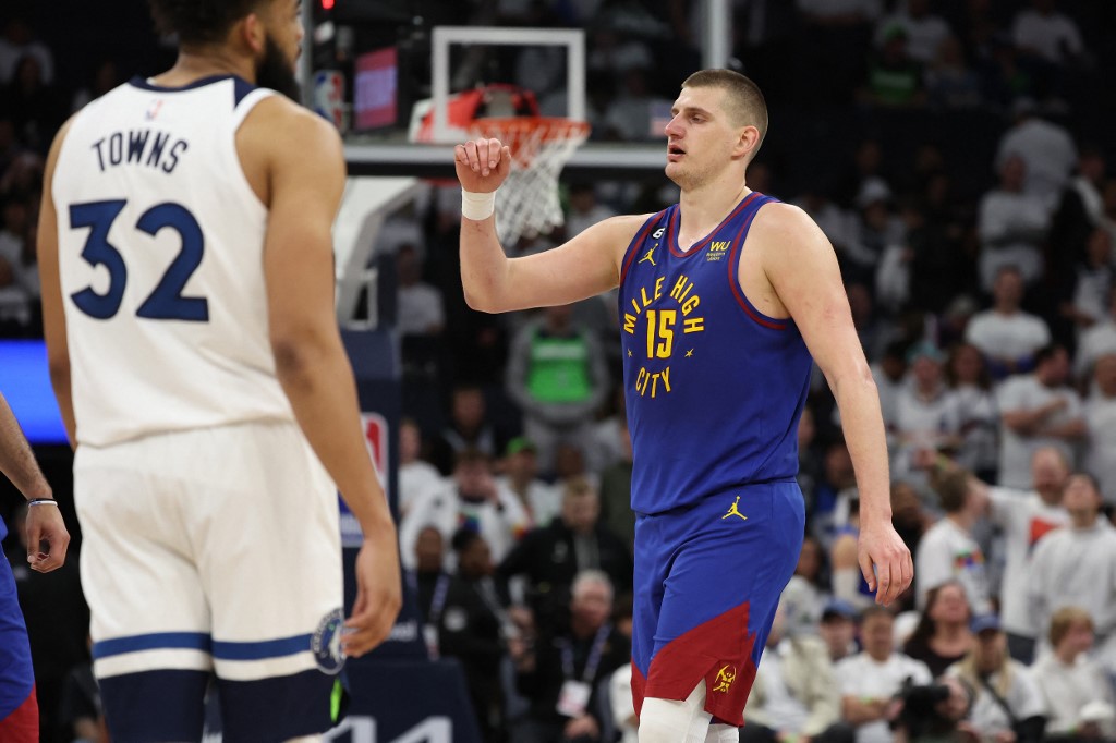 Nikola Jokic #15 of the Denver Nuggets reacts in the second half next to Karl-Anthony Towns #32 of the Minnesota Timberwolves during Game Three of the Western Conference First Round Playoffs at Target Center on April 21, 2023 in Minneapolis, Minnesota