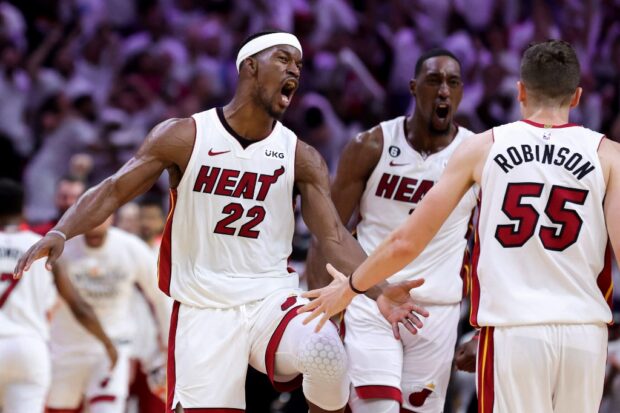 Jimmy Butler #22, Bam Adebayo #13 and Duncan Robinson #55 of the Miami Heat celebrate during the fourth quarter against the Milwaukee Bucks in Game Four of the Eastern Conference First Round Playoffs at Kaseya Center on April 24, 2023 in Miami, Florida.