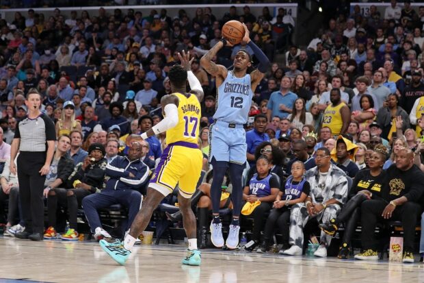 Ja Morant #12 of the Memphis Grizzlies takes a shot against Dennis Schroder #17 of the Los Angeles Lakers during the second half of Game Five of the Western Conference First Round Playoffs at FedExForum on April 26, 2023 in Memphis, Tennessee.