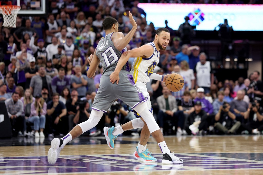  Stephen Curry #30 of the Golden State Warriors is guarded by Keegan Murray #13 of the Sacramento Kings during the second half of Game Five of the Western Conference First Round Playoffs at Golden 1 Center on April 26, 2023 in Sacramento, California. 