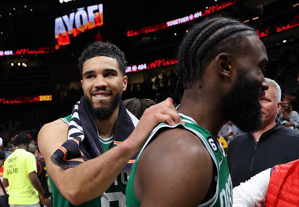 Jayson Tatum #0 of the Boston Celtics celebrates their 128-120 win over the Atlanta Hawks with Jaylen Brown #7 after Game Six of the Eastern Conference First Round Playoffs at State Farm Arena on April 27, 2023 in Atlanta, Georgia.