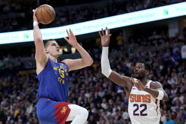 Nikola Jokic #15 of the Denver Nuggets goes to the basket against Deandre Ayton #22 of the Phoenix Suns in the first quarter at Ball Arena on April 29, 2023 in Denver, Colorado. NOTE TO USER: User expressly acknowledges and agrees that, by downloading and/or using this photograph, User is consenting to the terms and conditions of the Getty Images License Agreement.   Matthew Stockman/Getty Images/AFP (Photo by MATTHEW STOCKMAN / GETTY IMAGES NORTH AMERICA / Getty Images via AFP)