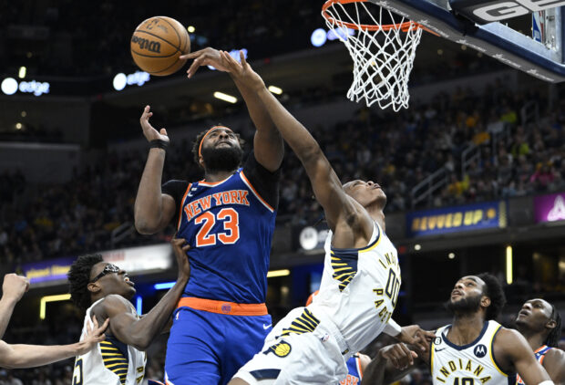 Apr 5, 2023; Indianapolis, Indiana, USA; New York Knicks center Mitchell Robinson (23) blocks a shot by Indiana Pacers guard Bennedict Mathurin (00) during the second half at Gainbridge Fieldhouse. Knicks won 138-129. 