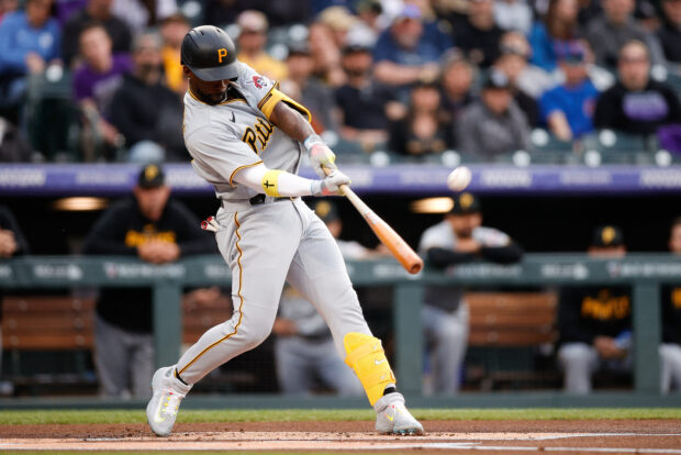 Apr 17, 2023; Denver, Colorado, USA; Pittsburgh Pirates designated hitter Andrew McCutchen (22) hits a solo home run in the first inning against the Colorado Rockies at Coors Field. 