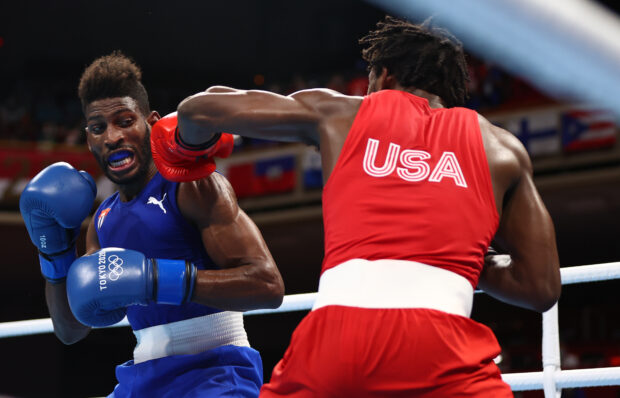 FILE PHOTO: Tokyo 2020 Olympics - Boxing - Men's Lightweight - Final - Kokugikan Arena - Tokyo, Japan - August 8, 2021. Keyshawn Davis of the United States in action against Andy Cruz of Cuba Pool 