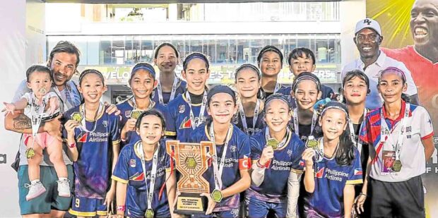 The Makati FC’s Girls 2011 receive their trophy. —CONTRIBUTEDPHOTOS