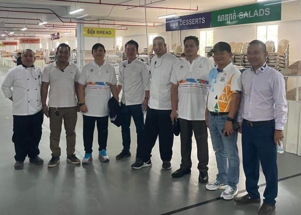 CHEF BRUCE LIM (fifth from left) poses with deputy chefs de mission Leonora “Len” Escollante (third from left) and Paolo Tancontian (sixth from left) and local chefs at the Athletes' Mess Hall in Phnom Penh.  -CONTRIBUTED PHOTO