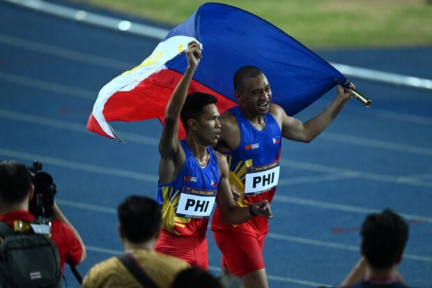 Members of the Philippines' relay team celebrate after winning the men's 4x400m final during the 32nd Southeast Asian Games (SEA Games) in Phnom Penh on May 12, 2023.