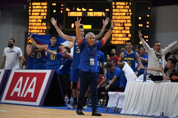 Gilas Pilipinas coach Vincent "Chot" Reyes (C) reacts after his team wins the men's basketball final against Cambodia at the 32nd Southeast Asian Games (SEA Games) in Phnom Penh on May 16, 2023. 