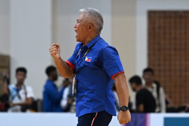 Philippines' coach Vincent "Chot" Reyes reacts after winning the men's basketball final against Cambodia at the 32nd Southeast Asian Games (SEA Games) in Phnom Penh on May 16, 2023. (Photo by MOHD RASFAN / AFP)