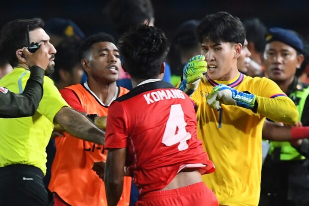 (FILES) Indonesia's Komang Teguh Trisnanda (C) and Thailand's Soponwit Rakyart (R) react as a fight breaks out on the sidelines of the men's football final match between Thailand and Indonesia during the 32nd Southeast Asian Games (SEA Games) in Phnom Penh on May 16, 2023
