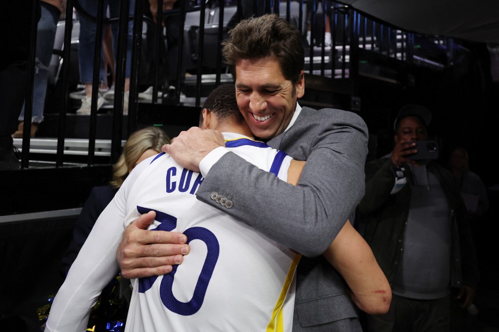 (FILES) Stephen Curry of the Golden State Warriors hugs general manager Bob Myers after the Warriors defeated the Kings 120-100 in game seven of the Western Conference First Round Playoffs at Golden 1 Center on April 30, 2023 