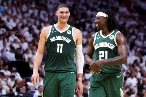 Brook Lopez #11 and Jrue Holiday #21 of the Milwaukee Bucks react during the second quarterback against the Miami Heat in Game Four of the Eastern Conference First Round Playoffs at Kaseya Center on April 24, 2023 in Miami, Florida.