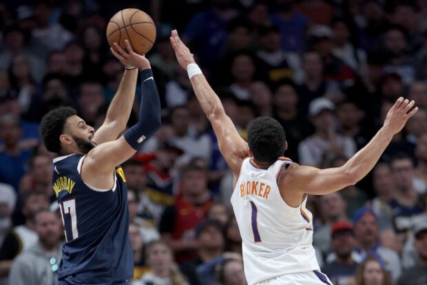 Jamal Murray #27 of the Denver Nuggets puts up a shot against Devin Booker #1 of the Phoenix Suns in the fourth quarter during Game Two of the NBA Western Conference Semifinals at Ball Arena on May 01, 2023 in Denver, Colorado.