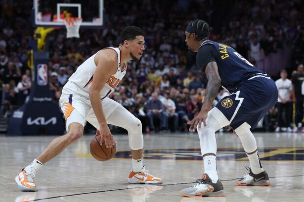 Devin Booker #1 of the Phoenix Suns drives against Kentavious Caldwell-Pope #5 of the Denver Nuggets in the fourth quarter during Game Two of the NBA Western Conference Semifinals at Ball Arena on May 01, 2023 in Denver, Colorado.