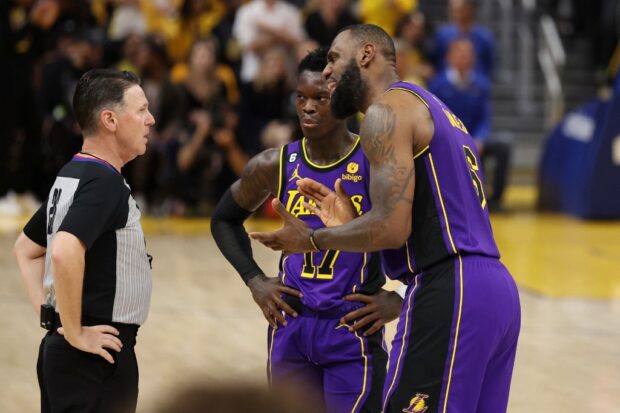 LeBron James #6 and Dennis Schroder #17 of the Los Angeles Lakers argue a call with referee Pat Fraher #26 during the third quarter against the Golden State Warriors in game two of the Western Conference Semifinal Playoffs at Chase Center on May 04, 2023 in San Francisco, California.