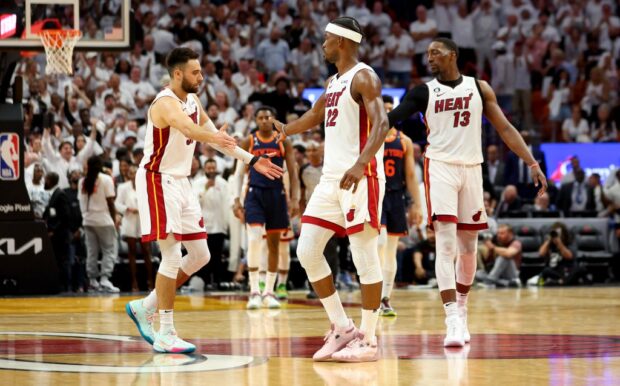 Jimmy Butler #22, Max Strus #31 and Bam Adebayo #13 of the Miami Heat shake hands during game six of the Eastern Conference Semifinals in the 2023 NBA Playoffs against the New York Knicks at Kaseya Center on May 12, 2023 in Miami, Florida.   