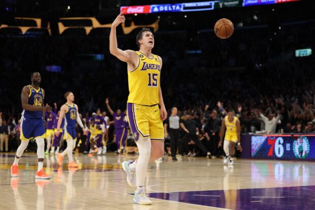Austin Reaves #15 of the Los Angeles Lakers celebrates after making a half court basket against the Golden State Warriors at the end of the second quarter in game six of the Western Conference Semifinal Playoffs at Crypto.com Arena on May 12, 2023 in Los Angeles, California.
