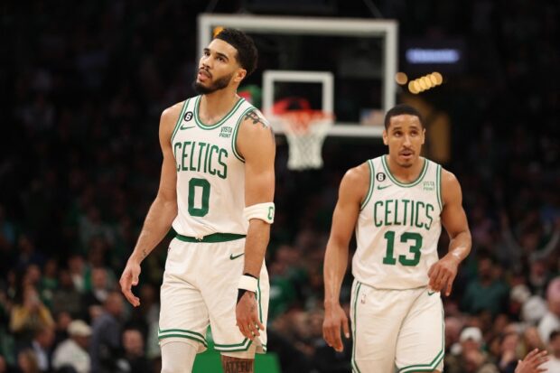 Jayson Tatum #0 and Malcolm Brogdon #13 of the Boston Celtics walk backcourt during the fourth quarter of game one of the Eastern Conference Finals against the Miami Heat at TD Garden on May 17, 2023 in Boston, Massachusetts. 