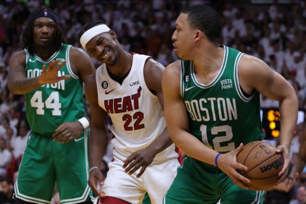 Grant Williams #12 of the Boston Celtics controls the ball ahead of Jimmy Butler #22 of the Miami Heat during the fourth quarter in game four of the Eastern Conference Finals at Kaseya Center on May 23, 2023 in Miami, Florida.
