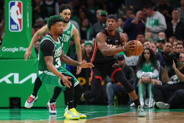 Jimmy Butler #22 of the Miami Heat controls the ball ahead of Marcus Smart #36 of the Boston Celtics during the third quarter in game five of the Eastern Conference Finals at TD Garden on May 25, 2023 in Boston, Massachusetts.