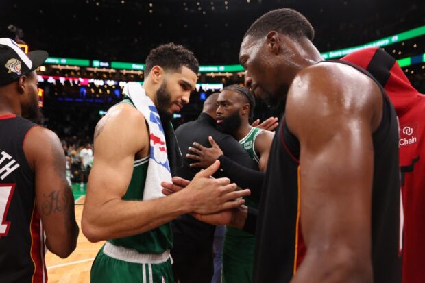  Jayson Tatum #0 of the Boston Celtics greets Bam Adebayo #13 of the Miami Heatafter the Heat defeated the Celtics 103-84in game seven of the Eastern Conference Finals at TD Garden on May 29, 2023 in Boston, Massachusetts. 