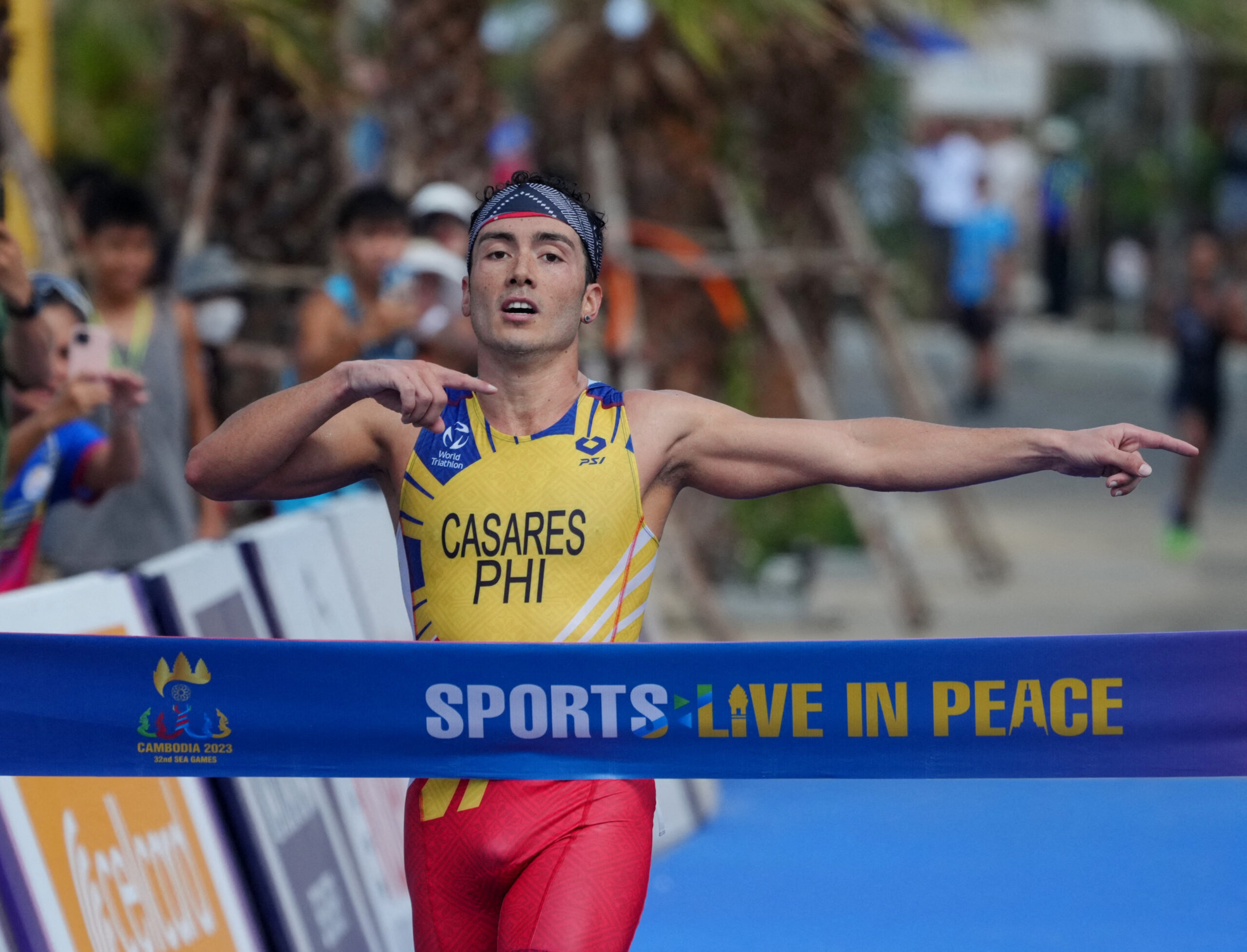 Southeast Asian Games - Triathlon - Individual - Kep, Cambodia - May 8, 2023 Philippines' Fernando Jose Tan Casares reacts as he crosses the line to win gold in the men's individual triathlon