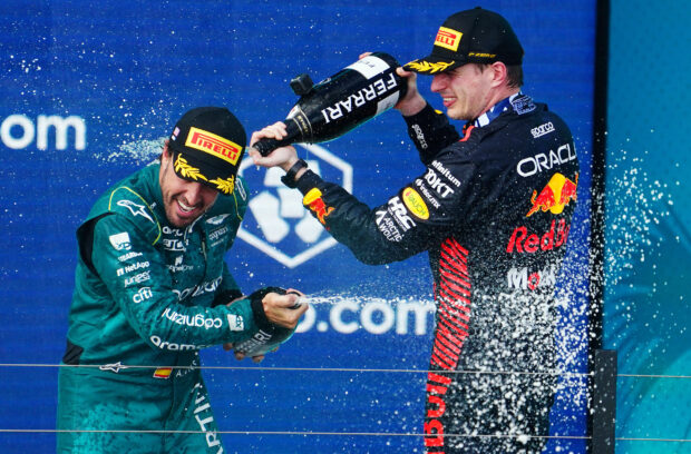 May 7, 2023; Miami Gardens, Florida, USA; Red Bull driver Max Verstappen (1) of the Netherlands and Aston Martin driver Fernando Alonso (14) of Spain celebrate after their finishes in the Miami Grand Prix at Miami International Autodrome.