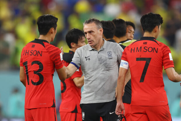 FILE PHOTO: Soccer Football - FIFA World Cup Qatar 2022 - Round of 16 - Brazil v South Korea - Stadium 974, Doha, Qatar - December 5, 2022 South Korea coach Paulo Bento with Son Jun-ho and Son Heung-min after the match as South Korea are eliminated from the World Cup