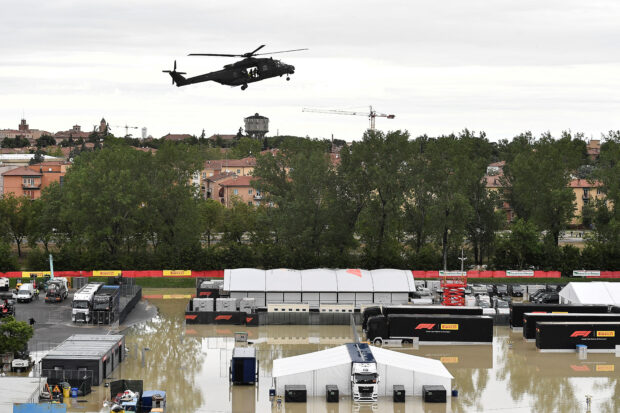 A helicopter flies above the closed Motor racing-Imola paddock, as Santerno river levels rise due to heavy rain, ahead of the weekend's Emilia Romagna Grand Prix, in Imola, Italy, May 17, 2023. 