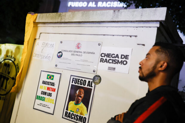 FOTO DE ARCHIVO: inscripción "El fuego del racismo" Se ve a personas protestando en solidaridad con el futbolista del Real Madrid Vinicius Jr., quien fue abusado racialmente durante un partido de clubes en España, frente al consulado español en Sao Paulo, Brasil, el 23 de mayo de 2023.