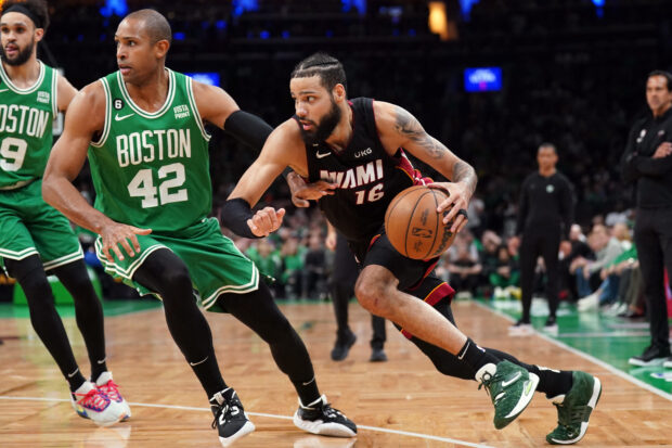 May 29, 2023; Boston, Massachusetts, USA; Miami Heat forward Caleb Martin (16) controls the ball against Boston Celtics center Al Horford (42) in the second quarter during game seven of the Eastern Conference Finals for the 2023 NBA playoffs at TD Garden. 