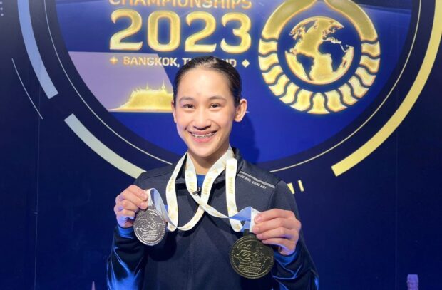 Islay Erika Bomogao holds up her gold and silver medals from the 2023 IFMA Senior World Championships.  -MAP PHOTO